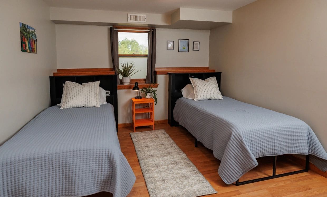 Bedroom with two twin beds and a window