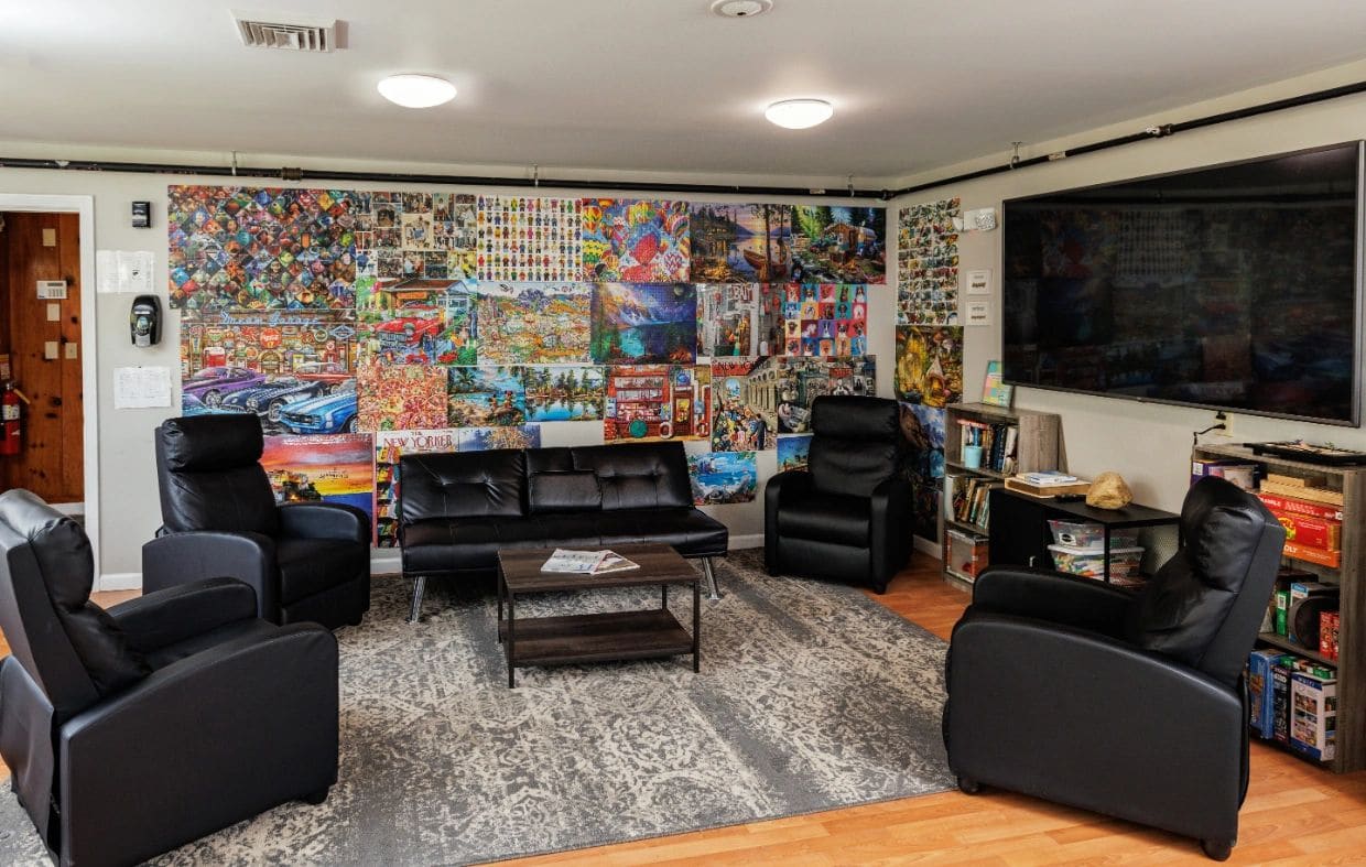 Common lounge with recliners and a mural wall